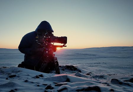 Movie camera shoots in nature.